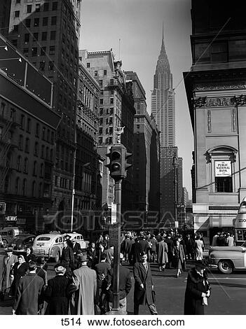 Picture - 1940S Anonymous Pedestrian Crowd Taxis Crossing Intersection 42Nd Street & 5Th Avenue Stop Lights Chrysler Building Nyc Usa. Fotosearch