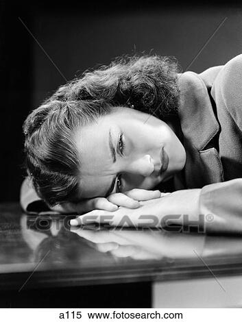 1940S Sad Young Woman Lying Head On Her Hands On Table Desk Pain Sadness Worry View Large Photo Image Stock Photography - 1940S Sad Young Woman Lying Head On Her Hands On Table Desk Pain Sadness Worry . Fotosearch