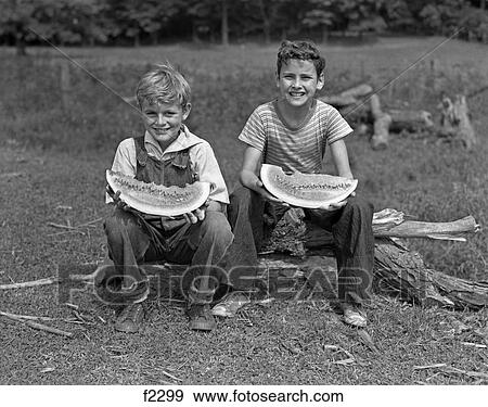 1940S Two Smiling Boys Eating Watermelons Looking At Camera View Large Photo Image Stock Photo - 1940S Two Smiling Boys Eating Watermelons Looking At Camera. Fotosearch