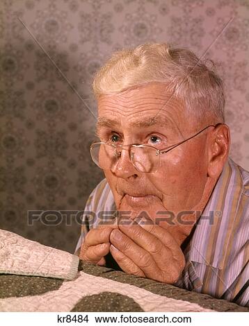 1950S 1960S Devout Senior Man Wearing Eyeglasses Saying Prayers At Night By Quilt Covered Bed View Large Photo Image Picture - 1950S 1960S Devout Senior Man Wearing Eyeglasses Saying Prayers At Night By Quilt Covered Bed . Fotosearch