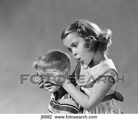 1950S 1960S Guess Who Girl Holds Her Hands Over Boys Eyes Blind Game Teasing Playing Boy Girls View Large Photo Image Stock Image - 1950S 1960S Guess Who Girl Holds Her Hands Over Boys Eyes Blind Game Teasing Playing Boy Girls. Fotosearch