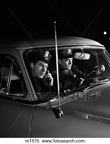 1950S Policemen Pair Driving At Night Passenger Officer Talking On Car Phone View Large Photo Image Stock Photography - 1950S Policemen Pair Driving At Night Passenger Officer Talking On Car Phone . Fotosearch