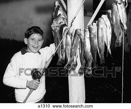 1950S Smiling Boy Proudly Displaying His Fish Catch Looking At Camera View Large Photo Image Stock Image - 1950S Smiling Boy Proudly Displaying His Fish Catch Looking At Camera. Fotosearch