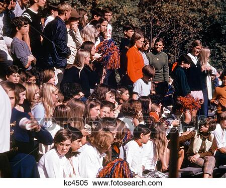 1960S 1970S High School Students Anxiously Watching Sporting Event View Large Photo Image Stock Photography - 1960S 1970S High School Students Anxiously Watching Sporting Event . Fotosearch