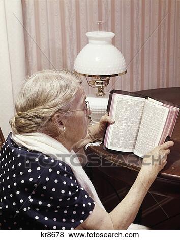 1960S Elderly Woman Reading Bible Sitting At Table View Large Photo Image Stock Photo - 1960S Elderly Woman Reading Bible Sitting At Table . Fotosearch