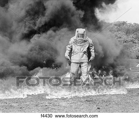 1960S Fireman In Asbestos Suit Standing In Smoke And Flames View Large Photo Image Stock Image - 1960S Fireman In Asbestos Suit Standing In Smoke And Flames. Fotosearch