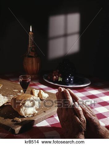 1960S Hands Folded In Prayer At Table With Bread Wine Candle Grapes Red White Checked Tablecloth View Large Photo Image Picture - 1960S Hands Folded In Prayer At Table With Bread Wine Candle Grapes Red White Checked Tablecloth . Fotosearch