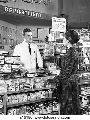 1960S Man Pharmacist Waiting On Woman Customer View Large Photo Image Stock Image - 1960S Man Pharmacist Waiting On Woman Customer. Fotosearch
