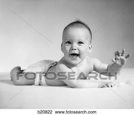 1960S Smiling Baby Wearing Cloth Diaper Lying On Stomach Looking At Camera Arm Raised View Large Photo Image Stock Image - 1960S Smiling Baby Wearing Cloth Diaper Lying On Stomach Looking At Camera Arm Raised. Fotosearch