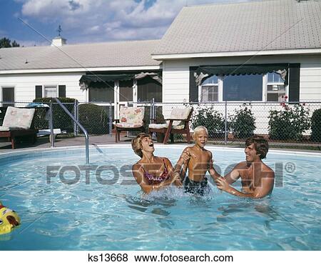 1970S Family Of Three Mother Dad Son Playing In Backyard Swimming Pool View Large Photo Image Stock Photo - 1970S Family Of Three Mother Dad Son Playing In Backyard Swimming Pool . Fotosearch