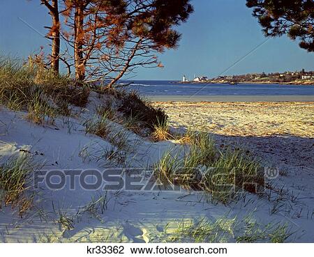 Stock Image - 1970S Sand Dune Beach In Foreground Annisquam Lighthouse In Background Cape Ann Ma Usa. Fotosearch