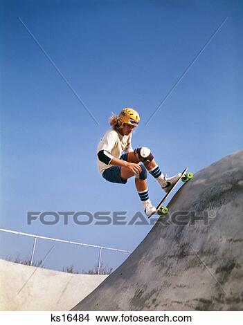 1970S Teenage Boy Wearing Safety Equipment Skate Boarding On Skateboard Obstacle Course View Large Photo Image Picture - 1970S Teenage Boy Wearing Safety Equipment Skate Boarding On Skateboard Obstacle Course. Fotosearch