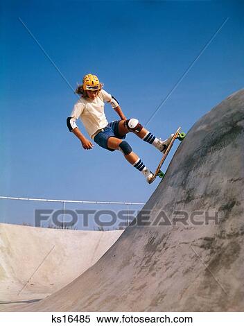 1970S Teenage Boy Wearing Safety Equipment Skate Boarding On Skateboard Obstacle Course View Large Photo Image Stock Photography - 1970S Teenage Boy Wearing Safety Equipment Skate Boarding On Skateboard Obstacle Course. Fotosearch