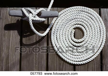 1980S Detail Of Cleat Hitch And Coiled Rope On Wooden Boat Dock View Large Photo Image Stock Image - 1980S Detail Of Cleat Hitch And Coiled Rope On Wooden Boat Dock. Fotosearch
