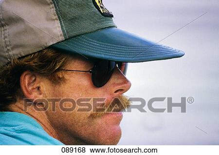 1980S Profile Portrait Of Man Wearing Sunglasses Mustache Ball Cap Wide Brim View Large Photo Image Stock Photo - 1980S Profile Portrait Of Man Wearing Sunglasses Mustache Ball Cap Wide Brim. Fotosearch
