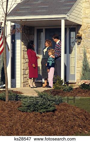 1980S Realtor Talking To Family Outside Of House For Sale View Large Photo Image Stock Photo - 1980S Realtor Talking To Family Outside Of House For Sale . Fotosearch