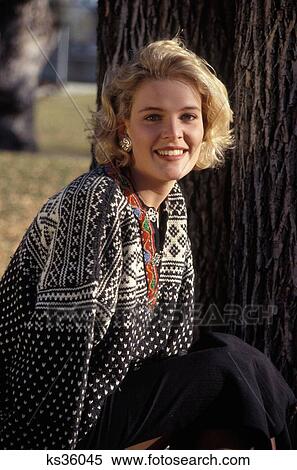 1990S Blonde Woman Wearing Sweater Sitting Near Tree Smiling Looking At Camera View Large Photo Image Stock Photography - 1990S Blonde Woman Wearing Sweater Sitting Near Tree Smiling Looking At Camera. Fotosearch