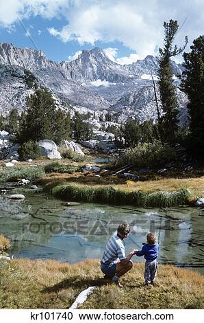 Stock Image - 1990S Father And Young Son By Mountain Stream In John Muir Wilderness California Usa. Fotosearch