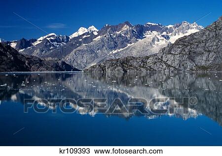 1990S Glacier Bay Mountains And Blue Sky Reflected In Water Alaska Usa View Large Photo Image Stock Image - 1990S Glacier Bay Mountains And Blue Sky Reflected In Water Alaska Usa. Fotosearch