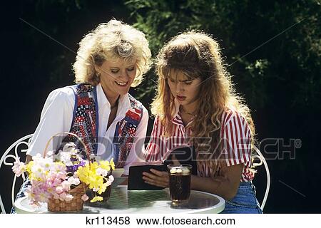 1990S Mother And Teenaged Daughter Together Reading Bible View Large Photo Image Stock Photo - 1990S Mother And Teenaged Daughter Together Reading Bible. Fotosearch