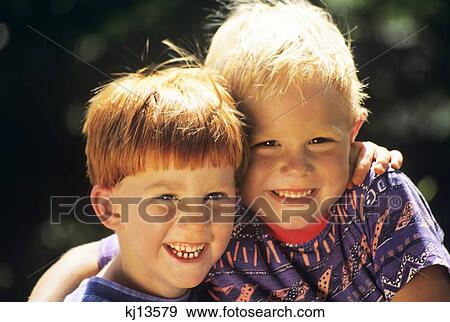 1990S Portrait Two Boys Smiling Blonde And Redhead Smiling Looking At Camera View Large Photo Image Stock Photo - 1990S Portrait Two Boys Smiling Blonde And Redhead Smiling Looking At Camera. Fotosearch