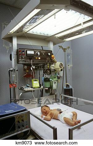 Stock Image - Newborn Infant In Hospital Nursery . Fotosearch