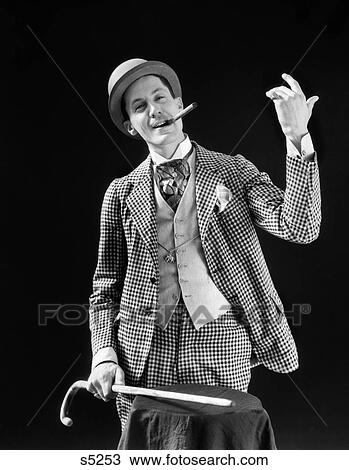 1910S 1920S Character Con Man Barker Bowler Hat Loud Vaudeville Type Clothes Holding Cane Smoking Cigar Confidence Game View Large Photo Image Stock Image - 1910S 1920S Character Con Man Barker Bowler Hat Loud Vaudeville Type Clothes Holding Cane Smoking Cigar Confidence Game. Fotosearch