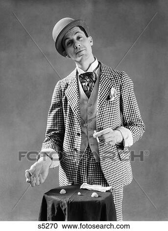 1910S 1920S Character Con Man Barker Bowler Hat Checked Three Piece Suite Demonstrating Shell Game View Large Photo Image Stock Image - 1910S 1920S Character Con Man Barker Bowler Hat Checked Three Piece Suite Demonstrating Shell Game . Fotosearch