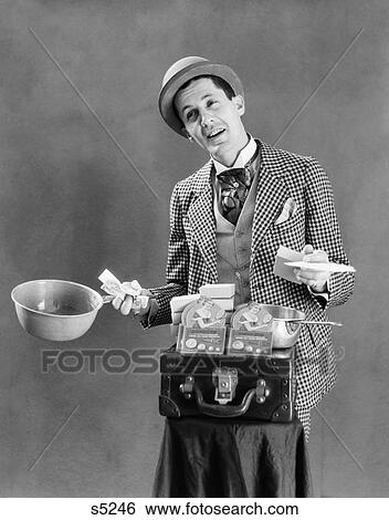 1910S 1920S Character Con Man Barker Traveling Salesman Wearing Bowler Hat Loud Vaudeville Type Clothing Selling Pots And Pans View Large Photo Image Stock Photograph - 1910S 1920S Character Con Man Barker Traveling Salesman Wearing Bowler Hat Loud Vaudeville Type Clothing Selling Pots And Pans. Fotosearch