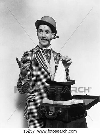 1910S 1920S Character Con Man Magician Bowler Hat Cigar Pulling Handkerchief Out Of Top Hat Confidence Game View Large Photo Image Stock Photo - 1910S 1920S Character Con Man Magician Bowler Hat Cigar Pulling Handkerchief Out Of Top Hat Confidence Game . Fotosearch