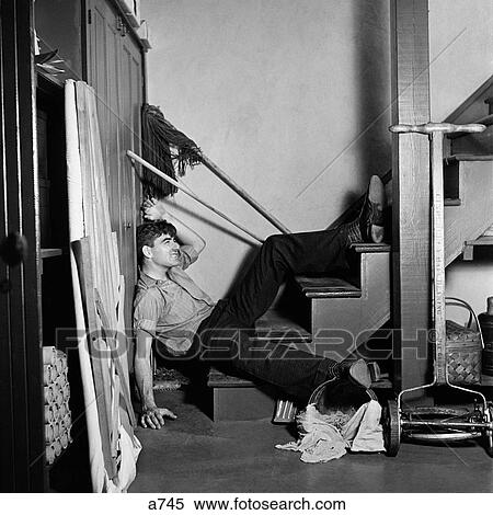 1930S 1940S Man Lying At Bottom Basement Stairs Fallen Household Accident Injury View Large Photo Image Stock Photography - 1930S 1940S Man Lying At Bottom Basement Stairs Fallen Household Accident Injury . Fotosearch