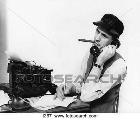 1930S 1940S Man Reporter On Phone Wearing Visor Smoking Cigar Sitting At Typewriter View Large Photo Image Stock Photo - 1930S 1940S Man Reporter On Phone Wearing Visor Smoking Cigar Sitting At Typewriter. Fotosearch