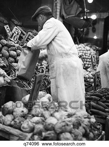 1930S Man Grocer Working Fruits And Vegetables Produce Market In New York City Usa View Large Photo Image Stock Photograph - 1930S Man Grocer Working Fruits And Vegetables Produce Market In New York City Usa. Fotosearch