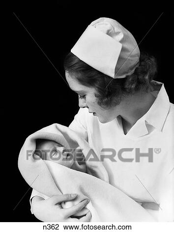 1940S 1930S Nurse Holding Newborn Infant View Large Photo Image Stock Image - 1940S 1930S Nurse Holding Newborn Infant . Fotosearch
