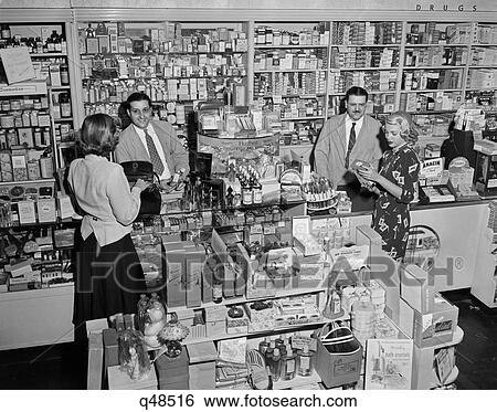 1940S 1948 Men Serving Women Shopping In Drugstore Pharmacy Store Counter Patient Medicine Cosmetics In Bronxville Ny Usa View Large Photo Image Stock Photograph - 1940S 1948 Men Serving Women Shopping In Drugstore Pharmacy Store Counter Patient Medicine Cosmetics In Bronxville Ny Usa. Fotosearch