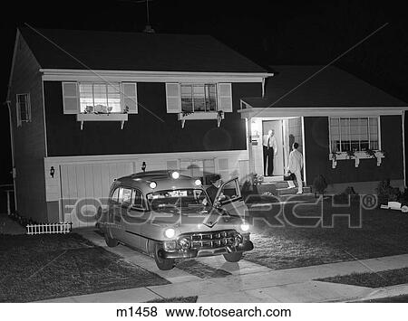 1950S Ambulance At Night Parked In Suburban Home Driveway With Door Open While Emt Driver Talks To Resident At House Door View Large Photo Image Stock Photo - 1950S Ambulance At Night Parked In Suburban Home Driveway With Door Open While Emt Driver Talks To Resident At House Door. Fotosearch