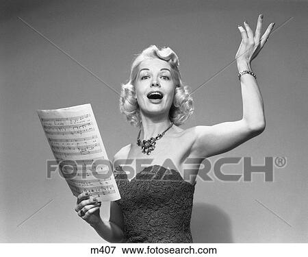 Stock Photo - 1950S Blond Woman Singing Holding Sheet Music Wearing Strapless Dress Necklace. Fotosearch