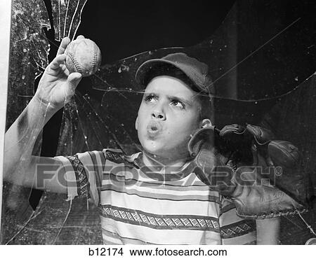 1950S Boy In Tee-Shirt & Cap Removing Baseball From Broken Window View Large Photo Image Picture - 1950S Boy In Tee-Shirt & Cap Removing Baseball From Broken Window. Fotosearch