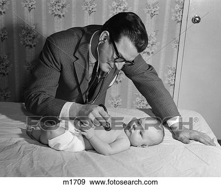 1950S Doctor On House Call Holding Stethoscope To Heart Of Baby Lying On Bed View Large Photo Image Stock Photo - 1950S Doctor On House Call Holding Stethoscope To Heart Of Baby Lying On Bed. Fotosearch