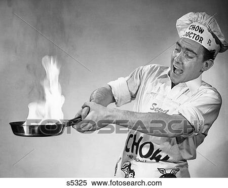 1950S Frantic Man Flaming Skillet Fry Pan On Fire Wearing Chef Hat And Apron View Large Photo Image Stock Photography - 1950S Frantic Man Flaming Skillet Fry Pan On Fire Wearing Chef Hat And Apron . Fotosearch