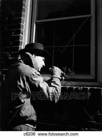 1950S Man Criminal Burglar Trying To Break Into Window Of Brick Building At Night View Large Photo Image Stock Photograph - 1950S Man Criminal Burglar Trying To Break Into Window Of Brick Building At Night. Fotosearch