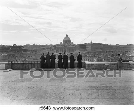 1950S Rome Italy Back View Of Student Priests Lined Up By Wall Overlooking City With View Of St. Peters Basilica In Background View Large Photo Image Stock Image - 1950S Rome Italy Back View Of Student Priests Lined Up By Wall Overlooking City With View Of St. Peters Basilica In Background. Fotosearch