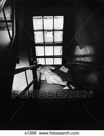 1950S Woman Lying At Bottom Of Dark Staircase Having Fallen Down Stairs View Large Photo Image Stock Photograph - 1950S Woman Lying At Bottom Of Dark Staircase Having Fallen Down Stairs . Fotosearch