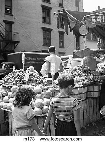 1950S Young Anonymous Girl And Boy Holding Hands Walking Past Produce Stall In Urban Outdoor Food Market Philadelphia Pa Usa View Large Photo Image Stock Image - 1950S Young Anonymous Girl And Boy Holding Hands Walking Past Produce Stall In Urban Outdoor Food Market Philadelphia Pa Usa. Fotosearch