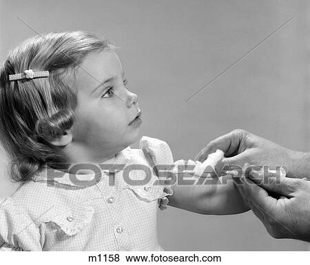 1960S 1960S Little Girl Getting Shot Hypodermic Needle Vaccination Injection Immunization Vaccine View Large Photo Image Stock Photo - 1960S 1960S Little Girl Getting Shot Hypodermic Needle Vaccination Injection Immunization Vaccine. Fotosearch