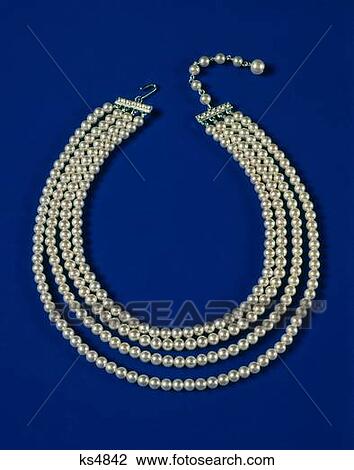 Stock Image - 1960S 1970S Four Strand Pearl Necklace On Blue Background . Fotosearch