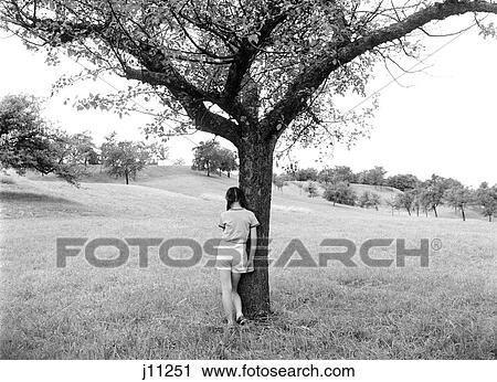 1960S Back View Of Girl Standing By Tree View Large Photo Image Stock Image - 1960S Back View Of Girl Standing By Tree. Fotosearch