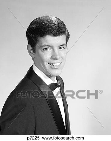 Stock Photography - 1960S Portrait Smiling Teenage Boy Wearing A Tuxedo Looking At Camera. Fotosearch