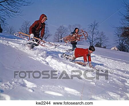 1960S Three Boys Sledding On Snow Covered Hillside View Large Photo Image Picture - 1960S Three Boys Sledding On Snow Covered Hillside . Fotosearch
