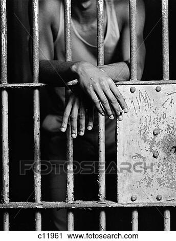 1970S African-American Male Hand Smoking Cigarette Through The Bars Of Jail Prison Cell View Large Photo Image Stock Image - 1970S African-American Male Hand Smoking Cigarette Through The Bars Of Jail Prison Cell . Fotosearch